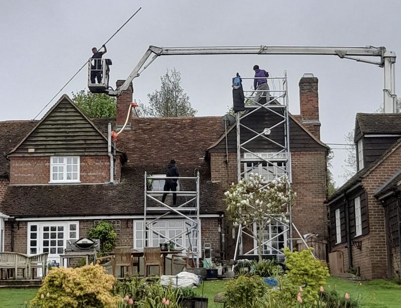 The Moss Cleaners using cherry picker and scaffolding to clean roof safely and professionally in Marchwood, Hampshire